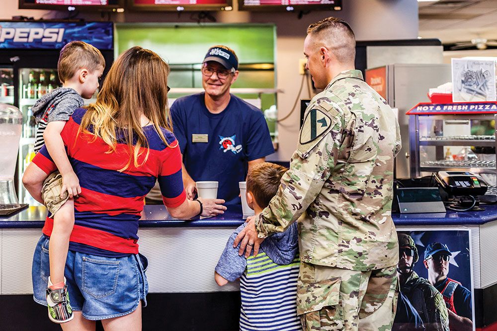 Man at counter serving family