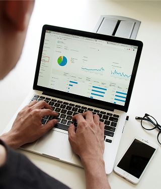 Person reducing their debt using a laptop computer